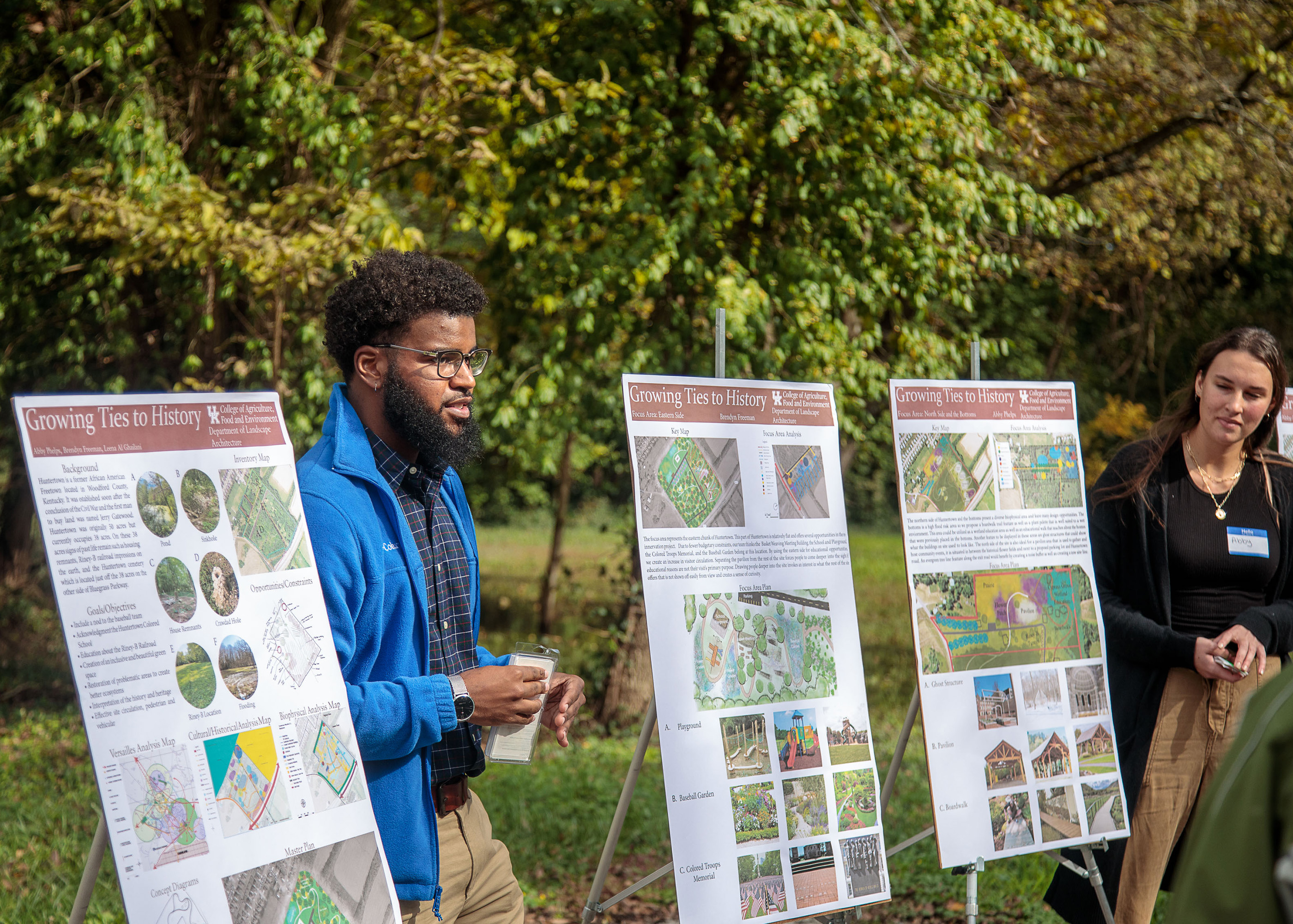 photograph of two students presenting to community members at Huntertown.