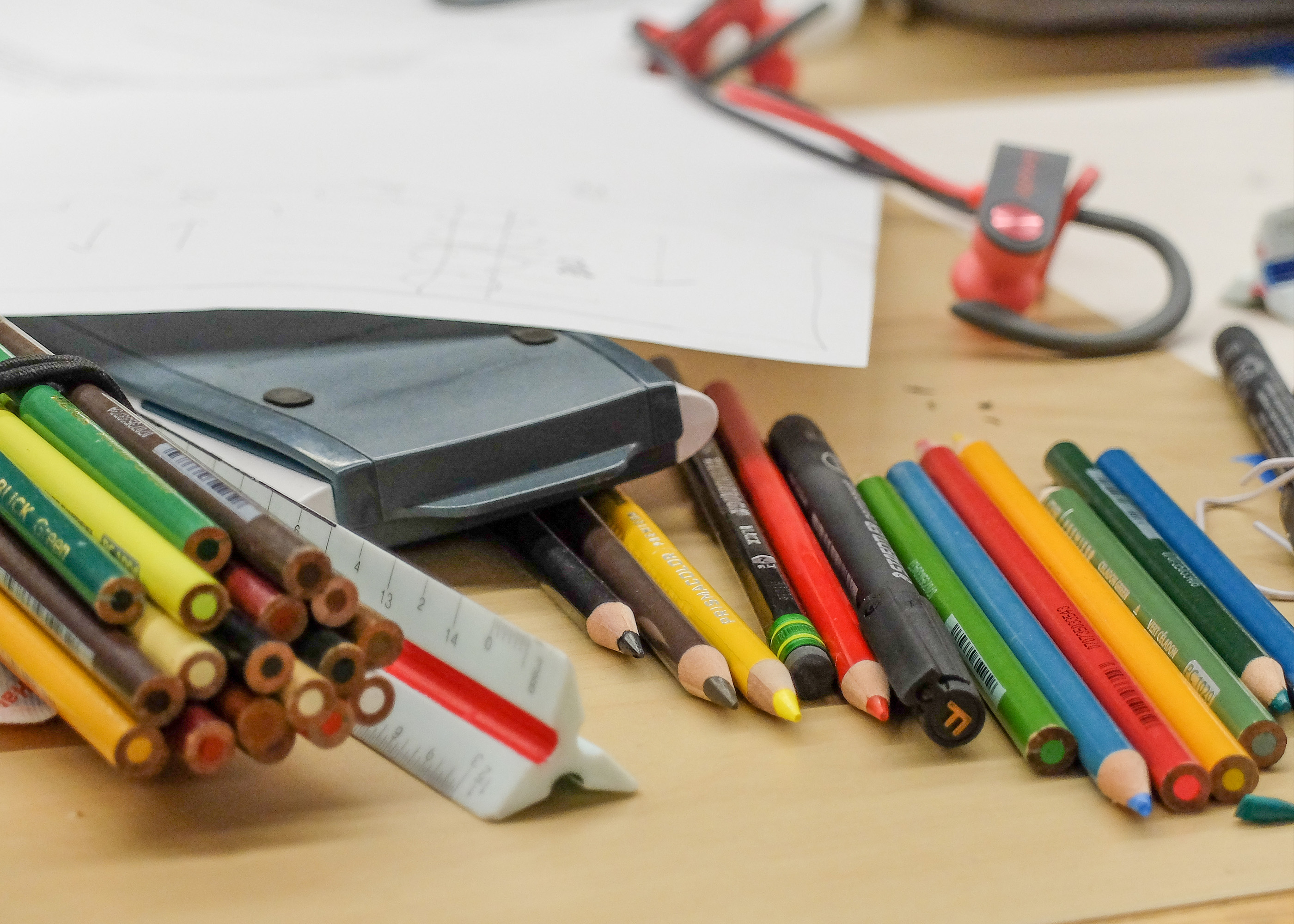 photograph of colored pencils, rulers, trace paper on a student desk