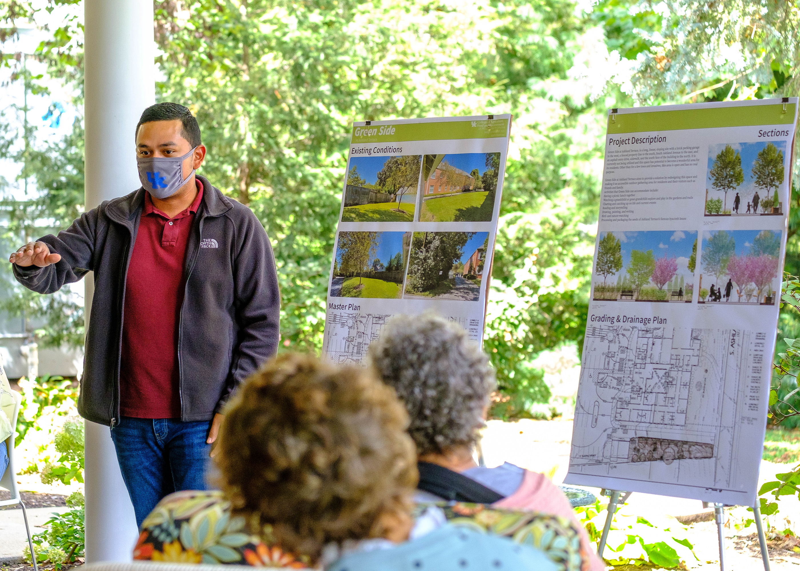 Photograph of student presenting his work to residents of Ashland Terrace