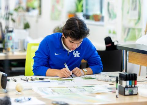 A student works on drawing in the studio
