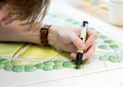 A student draws hand graphics